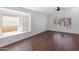 Open-concept living room featuring stylish wood floors and ample natural light from large, bright windows at 1120 N Val Vista Dr # 2, Gilbert, AZ 85234
