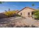 Desert landscaped backyard with neutral colored stucco house and red roof, a relaxing outdoor retreat at 11381 E Poinsettia Dr, Scottsdale, AZ 85259