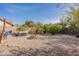 Spacious backyard with gravel landscaping, hot tub, and mature trees at 11381 E Poinsettia Dr, Scottsdale, AZ 85259
