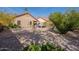 Backyard view features a hot tub, patio cover, and desert landscaping at 11381 E Poinsettia Dr, Scottsdale, AZ 85259