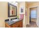 Bathroom boasts a wood vanity with a solid surface countertop and decorative mirror at 11381 E Poinsettia Dr, Scottsdale, AZ 85259