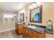 Bright bathroom with dual sinks, wooden cabinets, and a luxurious glass shower at 11381 E Poinsettia Dr, Scottsdale, AZ 85259