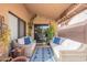 Relaxing covered patio area is complete with wicker seating and stylish decor at 11381 E Poinsettia Dr, Scottsdale, AZ 85259