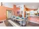 Bright dining room features a rustic wooden table with colorful chairs, and is adjacent to a modern kitchen at 11381 E Poinsettia Dr, Scottsdale, AZ 85259