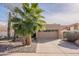 Inviting exterior showcasing a well-maintained front yard with a palm tree and rock landscaping at 11381 E Poinsettia Dr, Scottsdale, AZ 85259