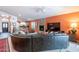Spacious living room with a fireplace, comfortable seating, and seamless flow to the kitchen at 11381 E Poinsettia Dr, Scottsdale, AZ 85259