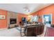 Bright living room featuring a fireplace, large sectional, and access to outdoor space at 11381 E Poinsettia Dr, Scottsdale, AZ 85259