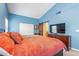 Spacious main bedroom featuring blue walls, ensuite bath access, and natural light at 11381 E Poinsettia Dr, Scottsdale, AZ 85259
