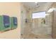 Bright and modern tiled shower featuring glass doors and chrome fixtures at 11381 E Poinsettia Dr, Scottsdale, AZ 85259