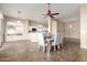 Bright dining area with stylish seating, open to the kitchen and outdoor views at 11664 W Eagle Ct, Surprise, AZ 85378