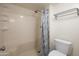 Bathroom with a bathtub, toilet, shower curtain, and built in shelving at 12212 N Paradise Village Pkwy # 308, Phoenix, AZ 85032