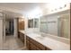 Bright bathroom featuring a double sink vanity with tile flooring and a framed mirror at 12212 N Paradise Village Pkwy # 308, Phoenix, AZ 85032