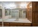 Bright bathroom featuring a double sink vanity with wooden cabinets and framed mirrors at 12212 N Paradise Village Pkwy # 308, Phoenix, AZ 85032