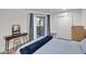 Serene bedroom boasts wood floors, private balcony, and convenient closet access for optimal storage at 12212 N Paradise Village Pkwy # 308, Phoenix, AZ 85032