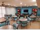 Community room with tables, chairs, a tv, and a variety of seating areas at 12212 N Paradise Village Pkwy # 308, Phoenix, AZ 85032
