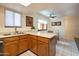 Cozy kitchen with natural wood cabinetry and eat-in dining at 12212 N Paradise Village Pkwy # 308, Phoenix, AZ 85032