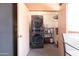 Convenient laundry area with a stacked washer and dryer and storage shelving at 12212 N Paradise Village Pkwy # 308, Phoenix, AZ 85032