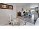 Spacious living area with tile flooring, glass top table, white chair and abundant natural light from the sliding doors at 12212 N Paradise Village Pkwy # 308, Phoenix, AZ 85032