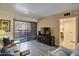 Bright living room with wood floors, balcony access, comfortable seating, and entertainment center at 12212 N Paradise Village Pkwy # 308, Phoenix, AZ 85032