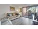 Cozy living room with a comfortable sofa, a view of the balcony and wood-style flooring at 12212 N Paradise Village Pkwy # 308, Phoenix, AZ 85032