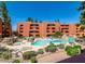 Community pool featuring lounge chairs and manicured landscaping for a resort like living at 12212 N Paradise Village Pkwy # 308, Phoenix, AZ 85032