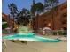 Exterior view of the pool area in the evening with lounge chairs and a waterfall at 12212 N Paradise Village Pkwy # 308, Phoenix, AZ 85032
