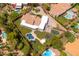 Aerial view of a single-Gathering home featuring a pool, playground, and lush landscaping at 12755 N 99Th Pl, Scottsdale, AZ 85260