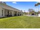 Expansive backyard with a lush green lawn, covered patio and pool cabana at 12755 N 99Th Pl, Scottsdale, AZ 85260