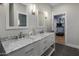 Spacious bathroom featuring double vanity with marble countertop and modern fixtures, open doorway at 12755 N 99Th Pl, Scottsdale, AZ 85260