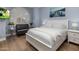 Stylish bedroom with white bedding, hardwood floors, and modern decor, flooded with natural light at 12755 N 99Th Pl, Scottsdale, AZ 85260