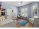 Charming bedroom with light blue walls, white trim and colorful decor, including plush rug at 12755 N 99Th Pl, Scottsdale, AZ 85260