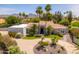 Stunning single-story home featuring mature landscaping, a circular driveway, and mountain views at 12755 N 99Th Pl, Scottsdale, AZ 85260