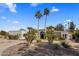 Beautiful home with circular driveway, palm trees and desert landscaping in Scottsdale, Arizona at 12755 N 99Th Pl, Scottsdale, AZ 85260