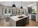 Open kitchen with stainless steel appliances, hardwood floors and views to the backyard at 12755 N 99Th Pl, Scottsdale, AZ 85260