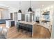 Modern kitchen featuring stainless appliances, quartz counters, a central island with seating, and hardwood floors at 12755 N 99Th Pl, Scottsdale, AZ 85260