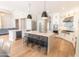 Modern kitchen featuring stainless steel appliances, a large island with bar stools, and hardwood floors at 12755 N 99Th Pl, Scottsdale, AZ 85260