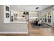 Open-concept kitchen with white cabinetry, stainless appliances, island and adjacent dining area at 12755 N 99Th Pl, Scottsdale, AZ 85260