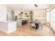 Modern kitchen with stainless steel appliances, island, dining area, and hardwood floors at 12755 N 99Th Pl, Scottsdale, AZ 85260