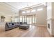 Open concept living room with kitchen view, fireplace, hardwood floors, and large windows at 12755 N 99Th Pl, Scottsdale, AZ 85260