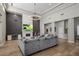Bright living room boasts hardwood floors, fireplace, modern lighting and comfortable seating at 12755 N 99Th Pl, Scottsdale, AZ 85260