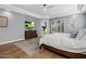 Bright bedroom with hardwood floors, a bed, and dresser at 12755 N 99Th Pl, Scottsdale, AZ 85260