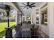 Covered patio with a large dining table, comfortable seating, and an outdoor television at 12755 N 99Th Pl, Scottsdale, AZ 85260