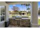 Outdoor kitchen with built-in grill and stone accents, overlooking landscaped backyard at 12755 N 99Th Pl, Scottsdale, AZ 85260