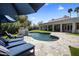 Stunning pool area with stone patio, water feature, lounge chairs, and landscaping, perfect for relaxation and entertaining at 12755 N 99Th Pl, Scottsdale, AZ 85260