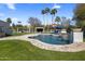 Beautiful backyard featuring a lagoon-style pool with waterfall, landscaping, and lounging areas at 12755 N 99Th Pl, Scottsdale, AZ 85260