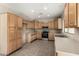 Well-lit kitchen with lots of cabinets, tiled floors and stainless steel oven/microwave at 12811 W Mulberry Dr, Avondale, AZ 85392