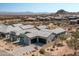 Wide aerial view of a stylish home with a three-car garage nestled in a scenic desert community at 13319 E Juan Tabo Rd, Scottsdale, AZ 85255