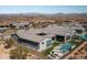 Expansive aerial shot of a luxurious desert home with a pool and lush backyard, showcasing serene outdoor living at 13319 E Juan Tabo Rd, Scottsdale, AZ 85255