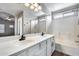 Bathroom with double vanity, shower, and bathtub combo at 14333 W Lexington Ave, Goodyear, AZ 85395