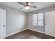 This bedroom features a closet, vinyl floors, and a ceiling fan at 14333 W Lexington Ave, Goodyear, AZ 85395